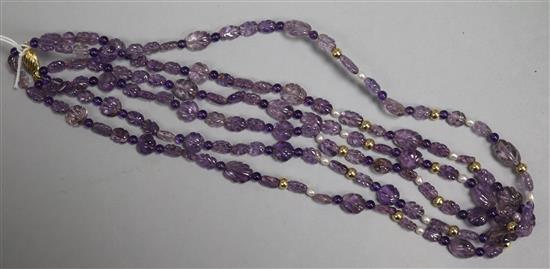 A double strand carved amethyst bead necklace with 9ct gold clasp and cultured pearl and gilt sphere spacers, 47cm.